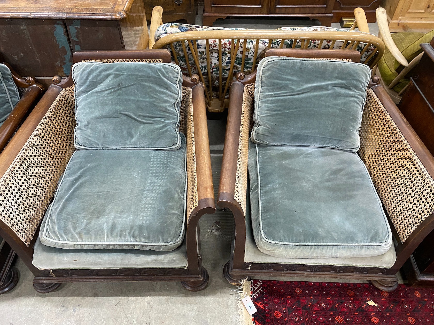 An early 20th century mahogany single caned three piece bergere suite, settee length 182cm, depth 77cm, height 68cm
